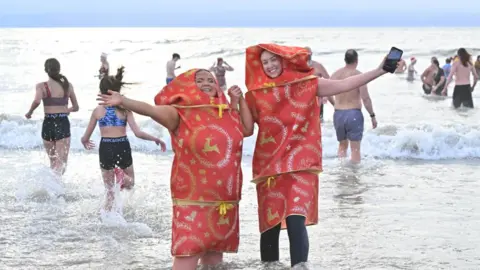 Wales News Service swimmers in fancy dress in sea