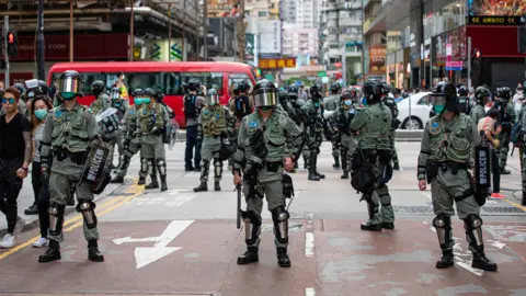 Getty Images Hong Kong police control access to a street in the central Mongkok neighbourhood during the demonstrations. A new wave of protests rise in Hong Kong at the news that the Chinese government will unilaterally pass the National Security Law 23.