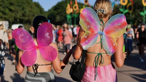 Two women wearing butterfly wings