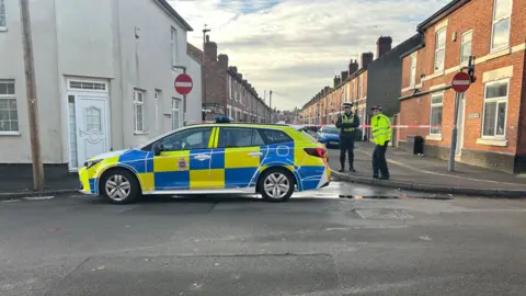 Liam Barnesand Police car in front of cordon
