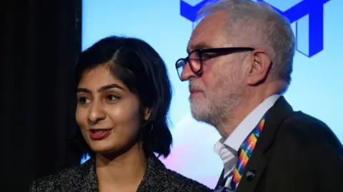 Zarah Sultana speaks with former Labour Party leader Jeremy Corbyn after addressing an audience at a fringe event for political festival The World Transformed.