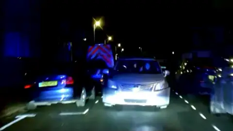 A head on shot of a car at night taken during a police chase in Reading. 