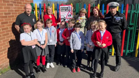 Handout Children from Chester-le-Street's Red Rose Primary School pictured with teachers and police officers