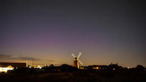 Weather Watchers/Coastal JJ The sky with a pink tinge with a windmill in the foreground