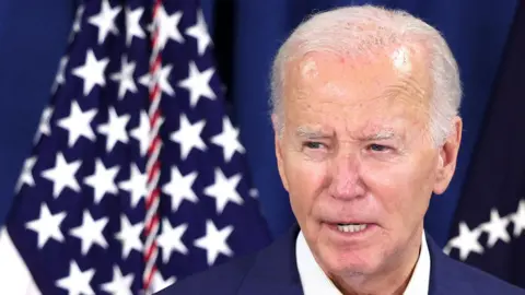 Reuters Joe Biden and a US flag