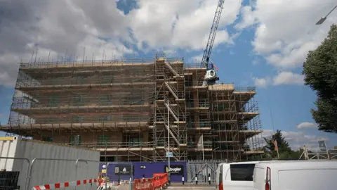 A building site with a crane in operation.