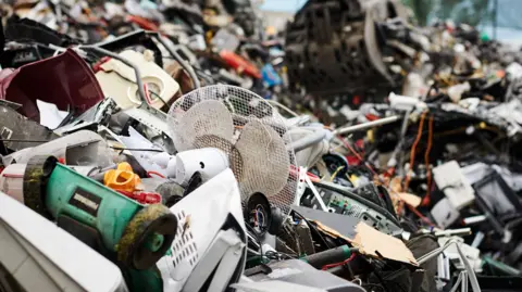 Recycle Your Electricals and SWEEEP Kuusakoski A pile of electrical waste at a recycling site