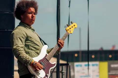 Jack Betts A man playing bass on stage