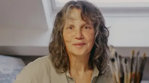 Peggy Pollock/Stockport Council Helen Clapcott in her studio with a selection of brushes behind her left shoulder