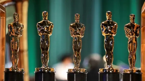 Getty Images Row of Oscar statuettes on display