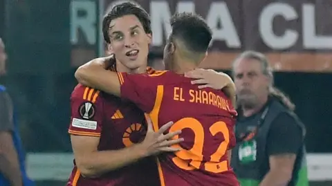 Edoardo Bove is hugged by a Roma team-mate after scoring a goal