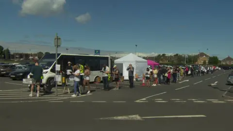 BBC People queue for vaccine in Bangor