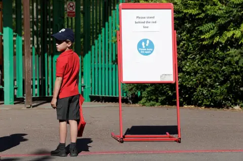 Eddie Keogh / Reuters A child waits to enter the school