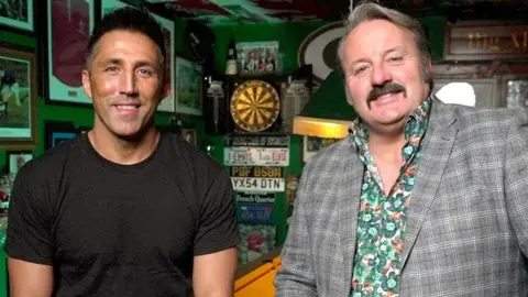 BBC Gavin Henson and Mike Bubbins smiling at the camera in Mike's bar
