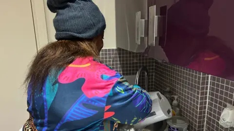 Woman pours hot water from kettle