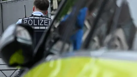 A police officer works at the scene after several people were injured in a knife attack on May 31, 2024 