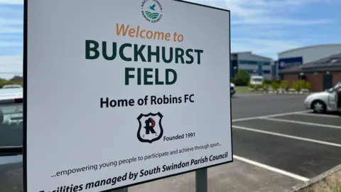 A sign sayign welcome to Buckhurst fields, Home of Robins FC.