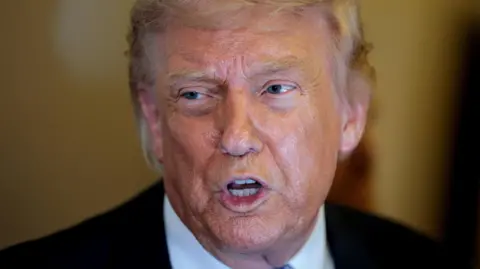 Donald Trump speaks to the press aboard Air Force One 