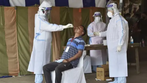 Hindustan Times Doctors taking swab from a person