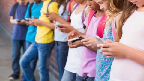 Getty Images Children on mobile phones