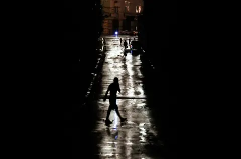 YAMIL LAGE/AFP People locomotion  connected  a darkened thoroughfare  owed  to a blackout pursuing  hurricane Rafael successful  Havana