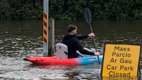 Kayaker in flooded car park