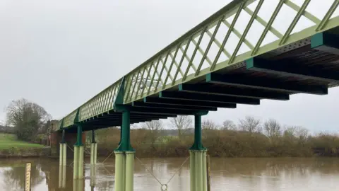 An image of a green bridge over the river Ure