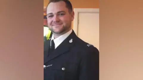 Family handout James Thistlethwaite has short dark hair and is wearing a police uniform