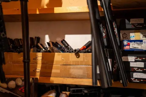 RCMP Firearms and ammunition are store on shelves in what appears to be a closet in a Dauphin, Manitoba home.
