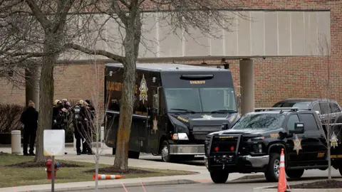 Oakland County Sheriff Deputies prepare to enter Temple Israel synagogue in West Bloomfield, Michigan, on March 13, 2026, after a person drove a vehicle into the synagogue a day earlier. 
