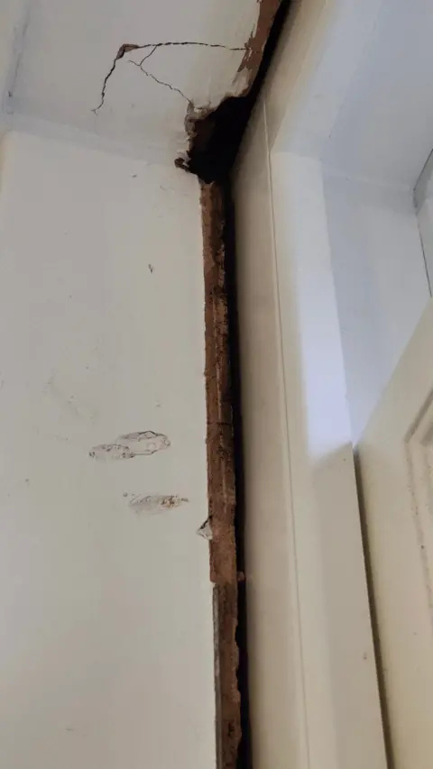 Charlie Cox Window frame sits badly in the wall with damage to the surrounding brickwork including cracks.
