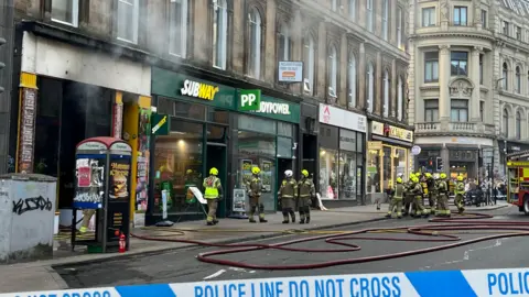 Union Street in Glasgow - teams of firefighters are tackling smoke coming from a row of shops, including a Subway sandwich and a Paddy Power.