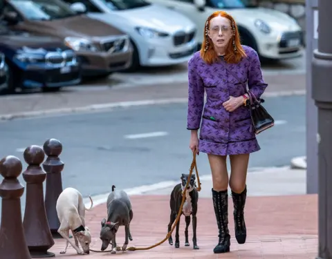 Mark Large/ANL/Shutterstock Ekaterina Barrett takes her three dogs for a stroll in Monaco. 8 June 2023