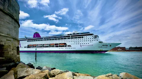 SATURDAY - A large white cruise ship sails into Portsmouth harbour passed the old walls