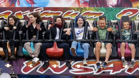 Paul Box Children on an amusement park ride at Weston Air Fest