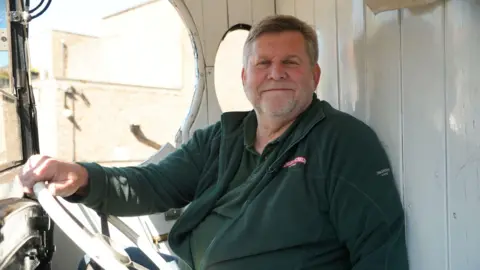 Qays Najm/BBC Volunteer & driver Chris Garrod from the Dad's Army museum, Thetford.