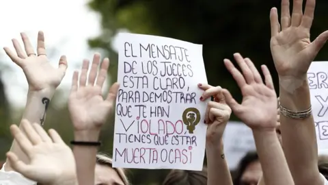 EPA A hand-made protest sign reads in Spanish: "The judges' message is clear. To prove you've been raped, you must be dead or nearly dead"