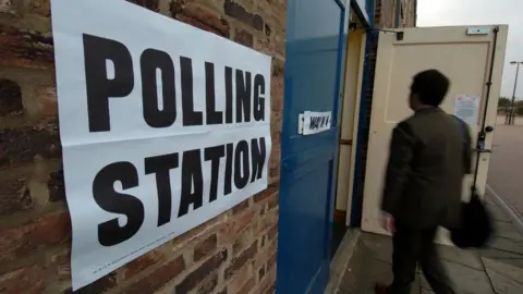 PA A man walks into a polling station