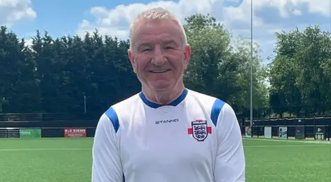 Mike Sweeney Mike Sweeney in his England football kit on a football pitch