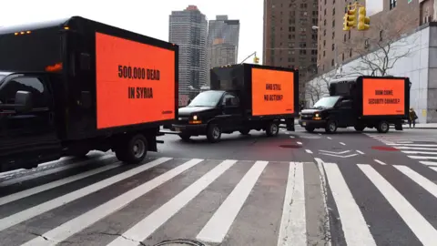 Getty Images Three vans bearing billboards in New York