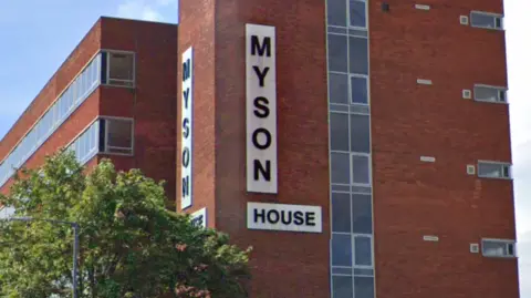 A red brick built multi-storey office block with the words Myson House on two sides