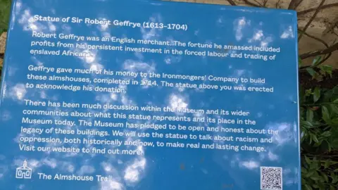 Julia Gregory Plaque from the Almshouse Trail, acknowledging the controversial nature of the statue