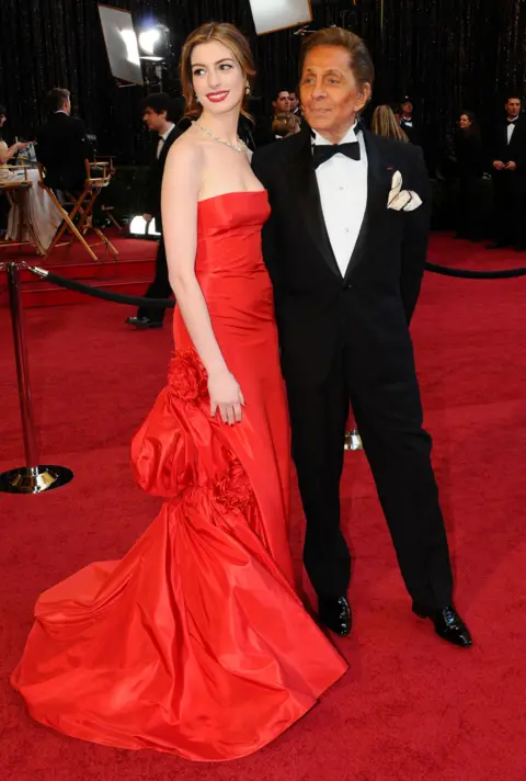 Getty Images Portrait of actress Anne Hathaway and fashion designer Valentino as they pose on the red carpet at the Kodak Theater during the 83rd Academy Awards, Hollywood, California, February 27, 2011.
