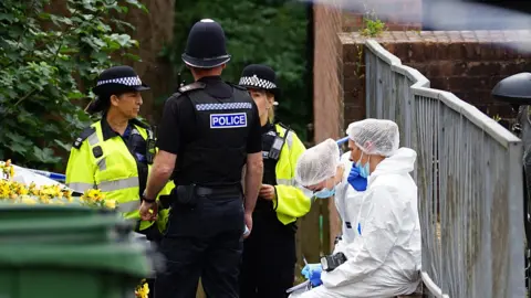 Dan Jessup police and forensic officers outside property