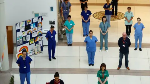 Reuters NHS staff observe a minute's silence in honour of key workers who have lost their lives due to COVID-19 at Mater Infirmorum Hospital, following the outbreak of the coronavirus disease (COVID-19), Belfast, Northern Ireland