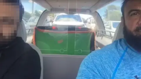 Ahmad Hraichie The father of one of the boys killed in the crash and undertaker Ahmad Hraichie sit in a hearse carrying the boy's coffin