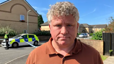 Neighbour Dominic Nutt, standing near the police cordon