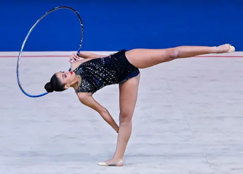 Noushad Thekkayil / Getty Images Habiba Aly of Egypt performs a daring hoop exercise during the International Rhythmic Gymnastics Tournament in Doha, Qatar - Wednesday 20 November 2024