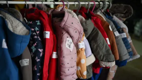 Baby coats on a clothes rack