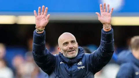 Enzo Maresca holds his hands in the air